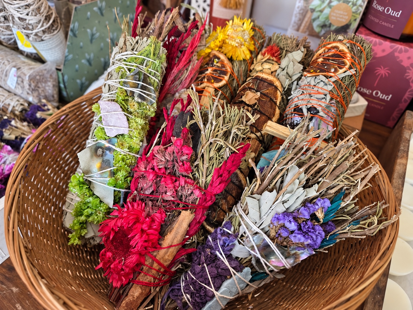 A colourful basket of hand-tied botanical smudge bundles